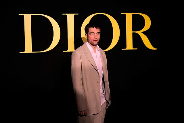 Robert Pattinson poses before Christian Dior Spring/Summer 2024 womenswear collection presented Tuesday, Sept.26, 2023 in Paris