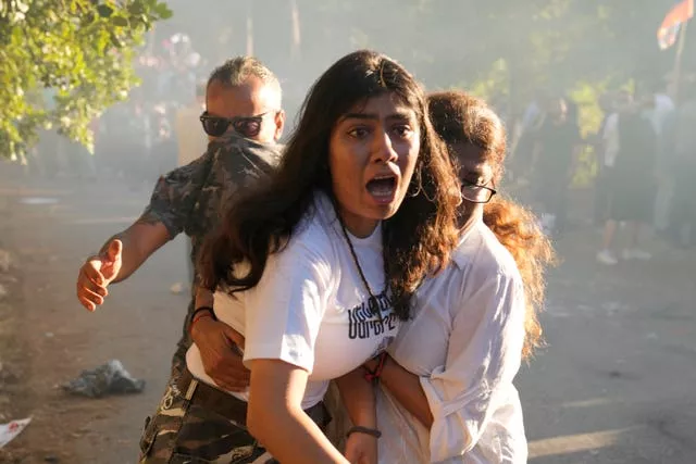 Lebanese Armenian woman reacts to tear gas outside the Azerbaijani embassy in Beirut