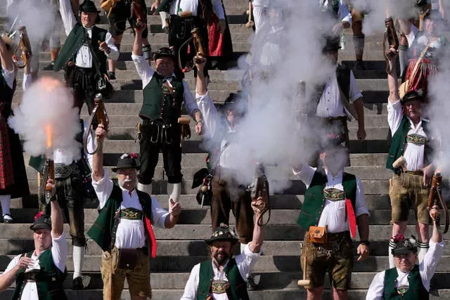 Bavarian riflemen and women in traditional costumes fire their muzzle loaders on the last day of the Oktoberfest beer festival in Munich, Germany, on October 3 2023
