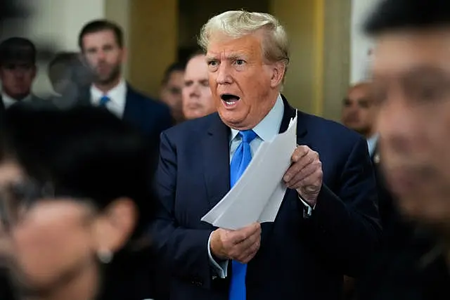 Donald Trump speaks to reporters during a lunch break