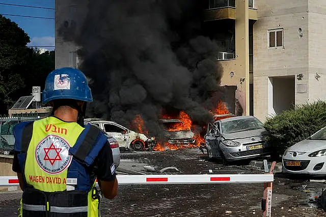 Vehicles burn after a rocket fired from the Gaza Strip hit a car park 