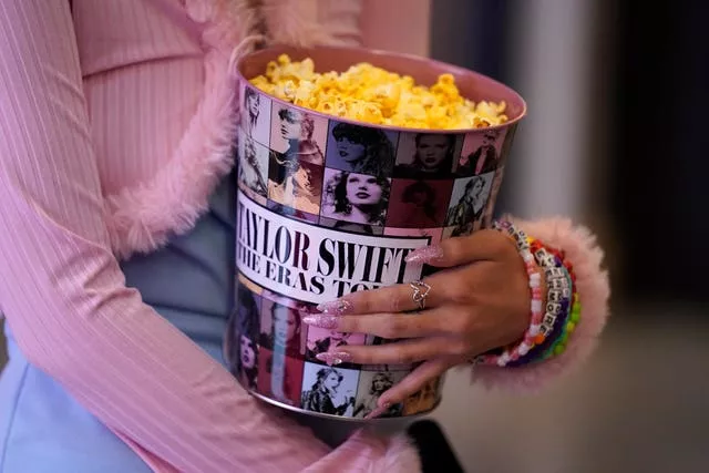 A fan attends the world premiere of Taylor Swift: The Eras Tour at AMC The Grove 14 in Los Angeles 