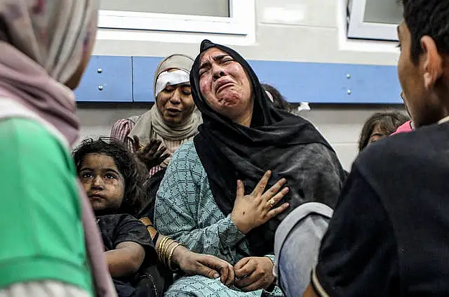 Wounded Palestinians wait for treatment at al Shifa hospital in Gaza City after arriving from al Ahli hospital following an explosion there