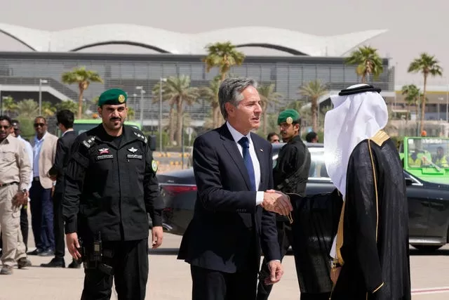 Mr Blinken shakes hands with a Saudi official before boarding a plane to leave Riyadh, Saudi Arabia, on Sunday 