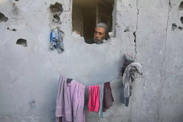 A Palestinian looks on from his house, damaged by Israeli airstrikes, in Rafah, southern Gaza Strip