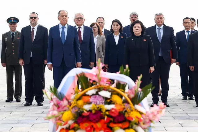 Russian foreign minister Sergei Lavrov, foreground left, and North Korean foreign minister Choe Son Hui, foreground right, attend a laying ceremony at the base of the bronze statues of North Korean late leaders Kim Il Sung and Kim Jong Il at Mansu Hill Grand Monument in Pyongyang, North Korea, on Thursday