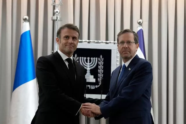 Emmanuel Macron shakes hands with Israeli president Isaac Herzog in Jerusalem