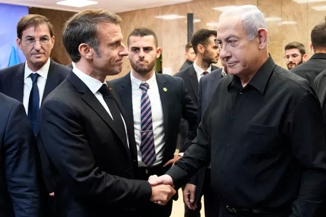 Israeli Prime Minister Benjamin Netanyahu shakes hands with French President Emmanuel Macron