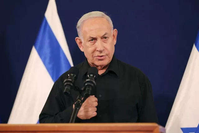 Benjamin Netanyahu speaks in front of an Israeli flag