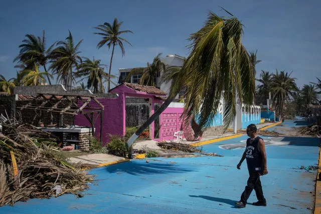 A man walks past a damaged area in the aftermath of Hurricane Otis in Acapulco, Mexico