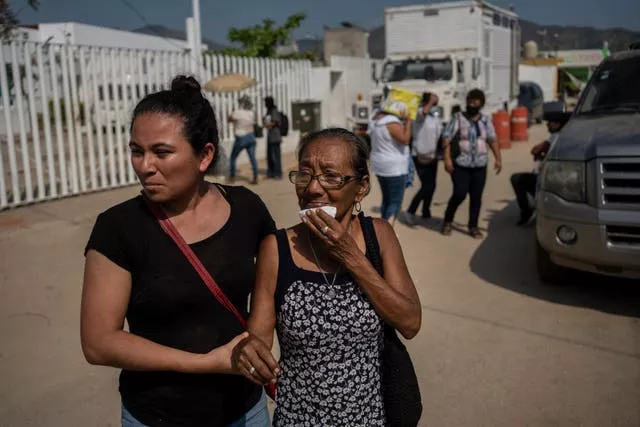 Relatives of Hurricane Otis victims seek information outside a morgue in Acapulco