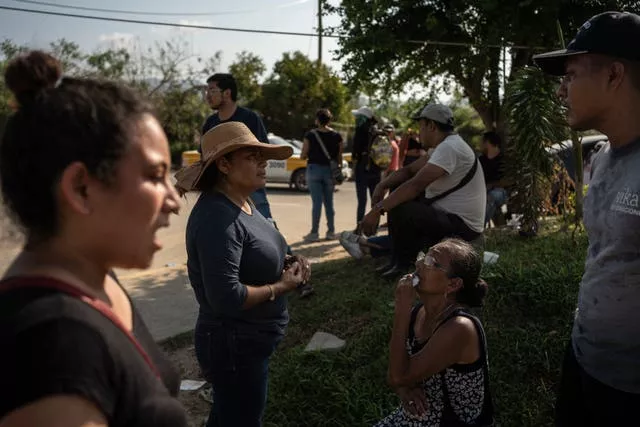 Relatives of Hurricane Otis victims seek information outside a mortuary in Acapulco, Mexico