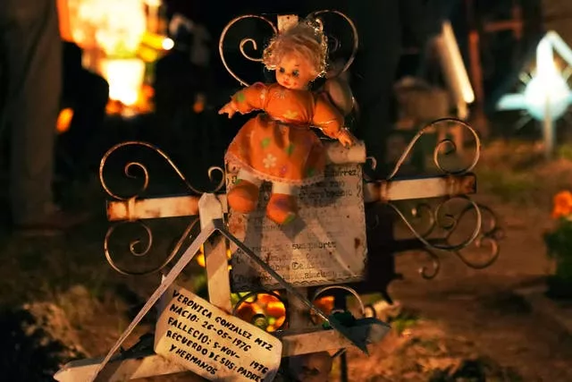 A doll decorates a newborn’s tomb