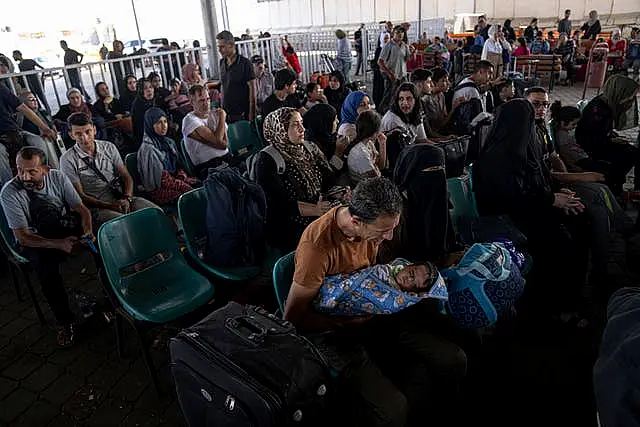 Palestinians wait to cross into Egypt at Rafah on Wednesday