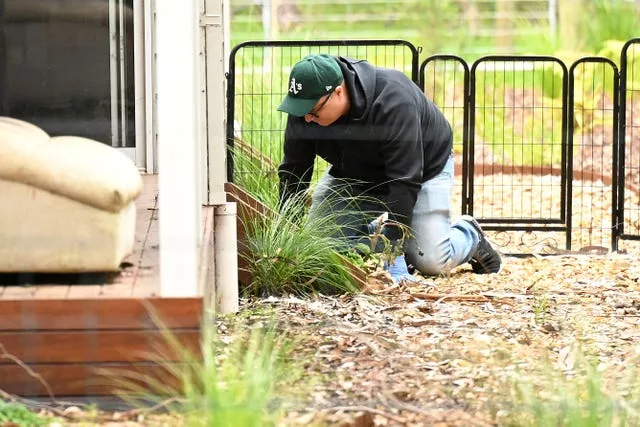 Detectives are seen searching the property of Erin Patterson in Leongatha, Victoria last year
