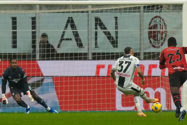 Udinese’s Roberto Pereyra scores a penalty against AC Milan