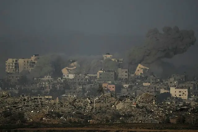 A building collapses following an Israeli air strike in the Gaza Strip, as seen from southern Israel 