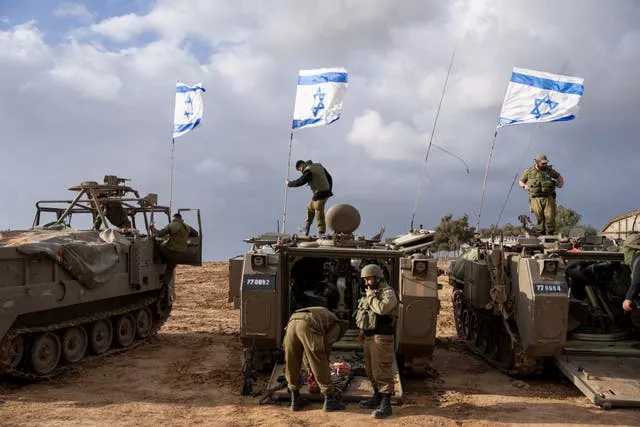 Israeli soldiers on armoured military vehicles