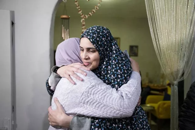 Marah Bakir, à direita, uma ex-prisioneira palestina que foi libertada pelas autoridades israelenses, é recebida na casa de sua família