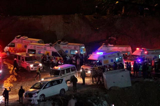 Ambulances drive past carrying workers rescued from the site of an under-construction road tunnel that collapsed in Silkyara in the northern Indian state of Uttarakhand, India