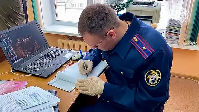 An investigator works at the scene of a shooting in a classroom of a school in Bryansk, Russia