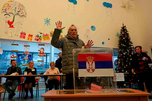 A man gestures after voting in Belgrade on Sunday