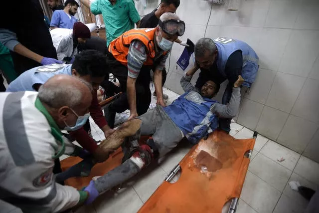 A United Nations worker wounded in Israeli airstrikes on a UN-run school arrives at the Nasser hospital in the town of Khan Younis, southern Gaza Strip, on Sunday 