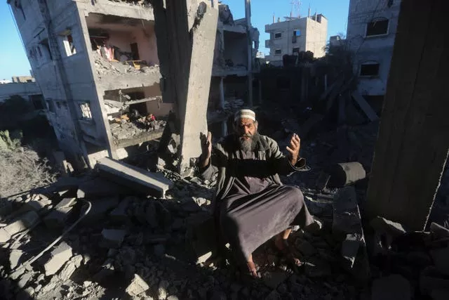 A Palestinian reacts after an Israeli strike on residential buildings in Rafah, Gaza Strip, on Friday