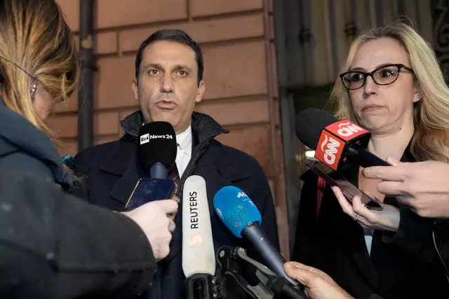 Cardinal Angelo Becciu's lawyers Fabio Viglione, left, and Maria Concetta Marzo speak to reporters after the verdict