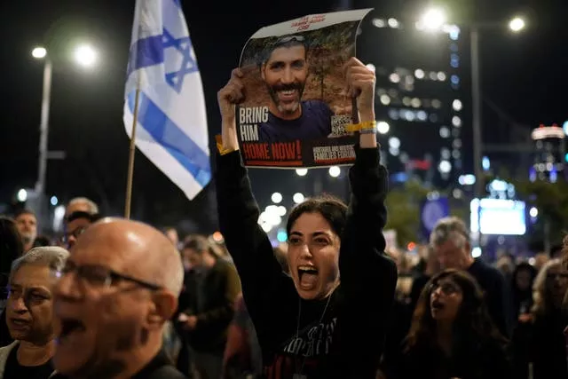 Families and supporters of Israeli hostages held by Hamas in Gaza hold their photographs and shout slogans at a rally calling for their return, in Tel Aviv, Israel, on Saturday