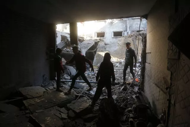 People clear up after an air strike
