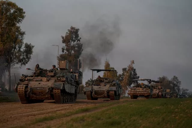 A convoy of Israeli army armoured personnel carriers moves near the Israeli-Gaza border, in southern Israel