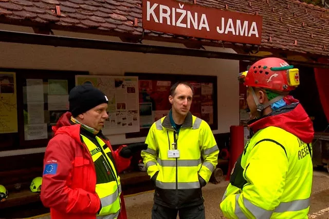 Rescuers gather outside the Krizna Jama cave near Grahovo, Slovenia