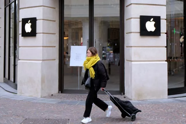A woman walks past an Apple store in Lille, northern France