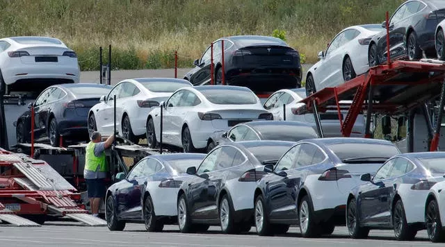 Tesla cars are loaded onto carriers