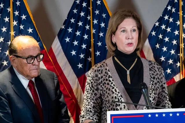 Sidney Powell next to former mayor of New York Rudy Giuliani in November 2020, in Washington