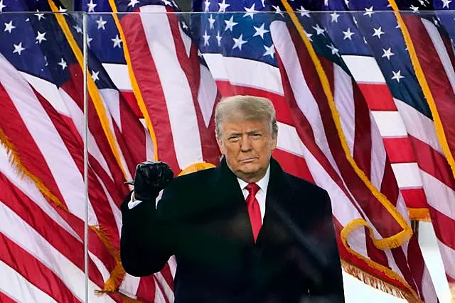 Former president Donald Trump gestures as he arrives to speak at a rally in Washington