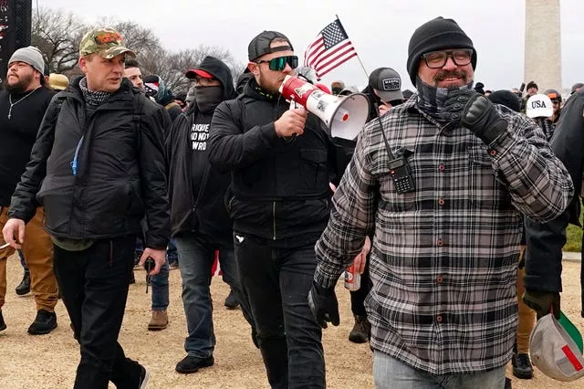 Proud Boys members including Zachary Rehl, left, Ethan Nordean, centre, and Joseph Biggs, walk towards the US Capitol in Washington, in support of President Donald Trump, on January 6 2021