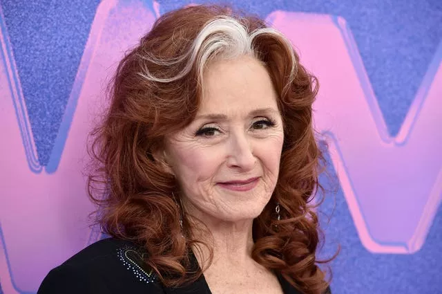 Head and shoulder shot of woman with red curly hair