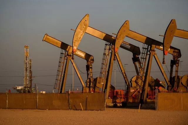 Pumpjacks operate near the site of a new oil and gas well being drilled in Midland, Texas 