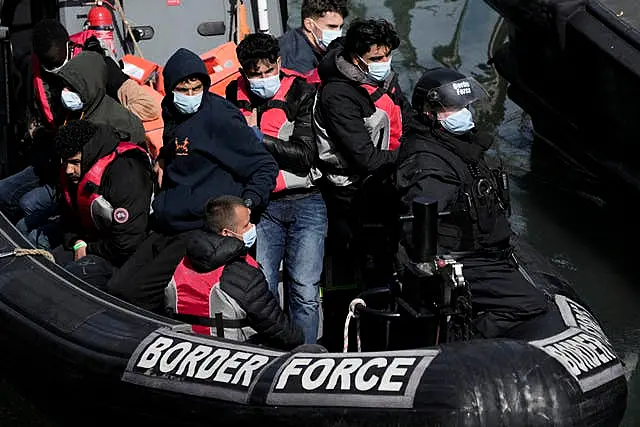 People thought to be migrants, who undertook the crossing from France in small boats and were picked up in the Channel, arrive to be disembarked from a small transfer boat which ferried them from a larger British border force vessel that did not come into the port, in Dover, south east England