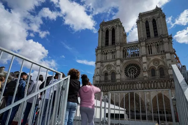 People have a close look at Notre Dame as they visit the rebuilding site during Heritage Day in Paris in September 2022