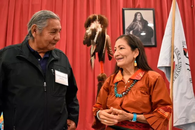 Russell Eagle Bear, with the Rosebud Sioux Reservation Tribal Council, speaks to Deb Haaland during a meeting about Native American boarding schools at Sinte Gleska University Schools