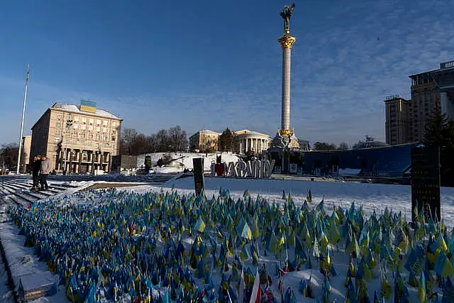 Flags wave at the memorial site for those killed during the war, in Independence Square in Kyiv, Ukraine