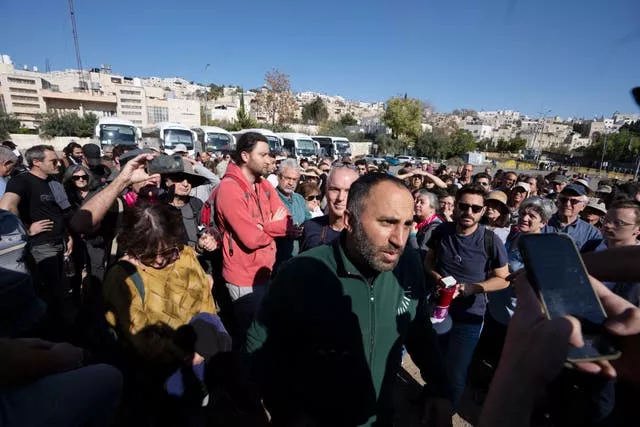 Palestinian activist Issa Amro, centre