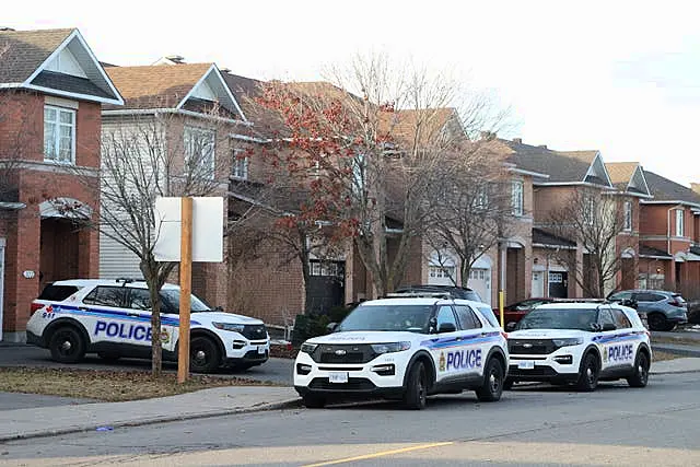 Police vehicles parked at the scene 