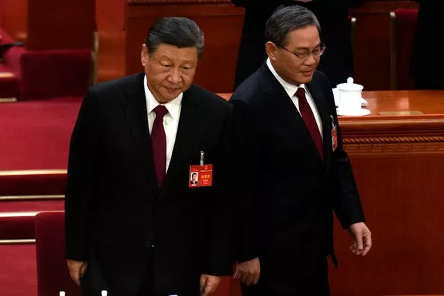Chinese President Xi Jinping, left, and Chinese Premier Li Qiang arrive for the opening session of the National People’s Congress in Beijing, China (Ng Han Guan/AP)
