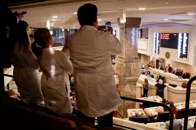 Doctors from an Alabama fertility clinic take photos as the Bill was voted on 