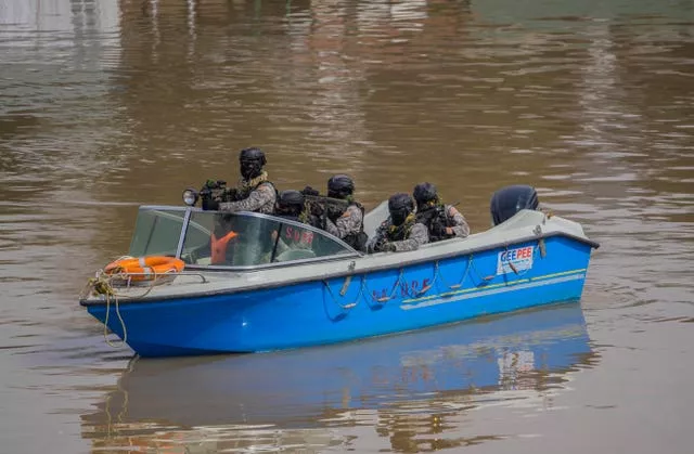 Soldiers patrol on a boat ahead of Mr Modi’s visit 