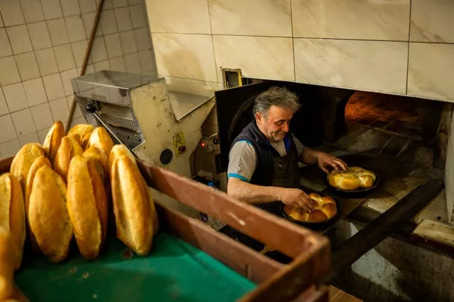 A man bakes bread in a popular bakery shop in Istanbul, Turkey 